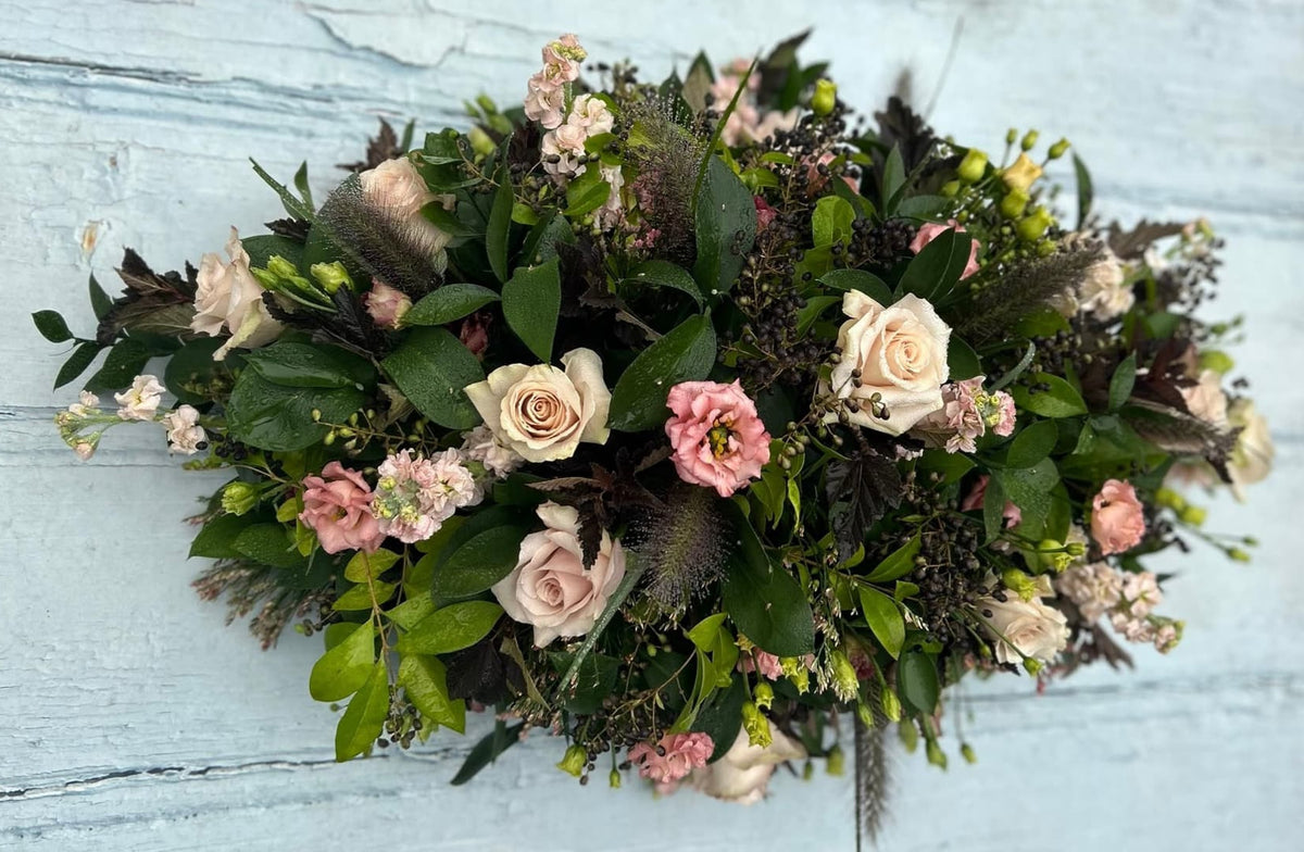 Autumnal double-ended compostable coffin spray with roses, lisianthus, stocks, grasses and seasonal foliage and berries, Tunbridge Wells.