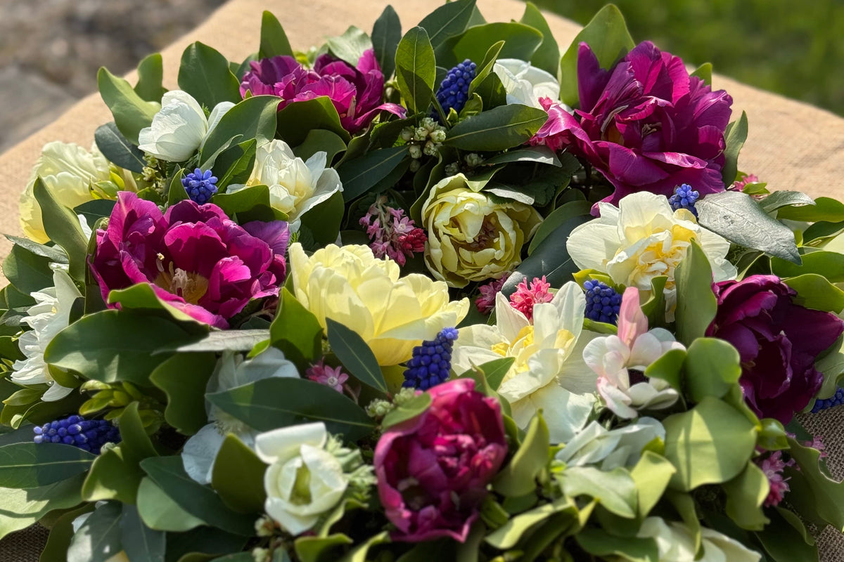 Compostable funeral wreath tribute with spring flowers including tulips, narcissi and muscari, Tunbridge Wells.